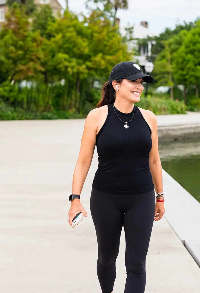 Julie Kaminski, board-certified health coach for women in midlife, walking outdoors in Charleston