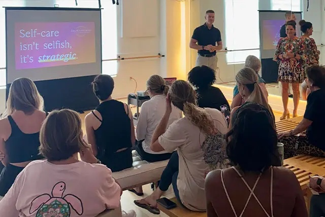 Julie Kaminski working as a women’s health coach at a wellness workshop